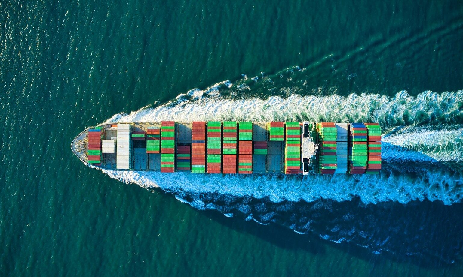aerial view of blue and white boat on body of water during daytime