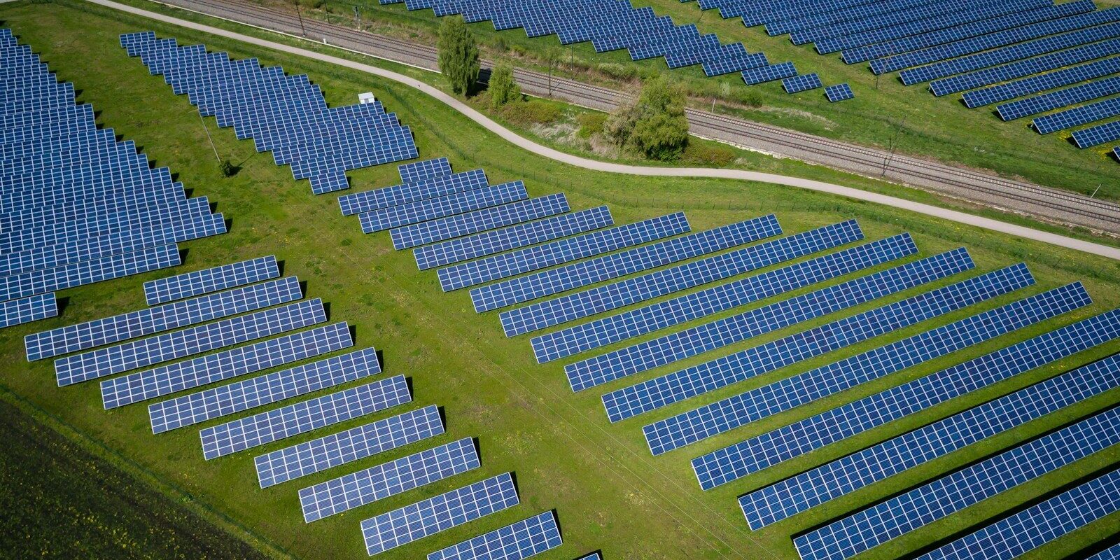 aerial photography of grass field with blue solar panels